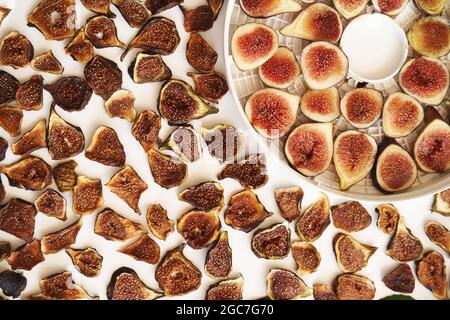 Dried and fresh figs on the table during the drying process Stock Photo