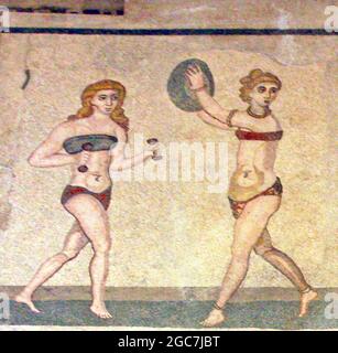 Roman Bikini Mosaics at The Villa Romana del Casale, Sicily, Italy. Early depiction of Roman women wearing bikinis from early 4th century AD. Stock Photo