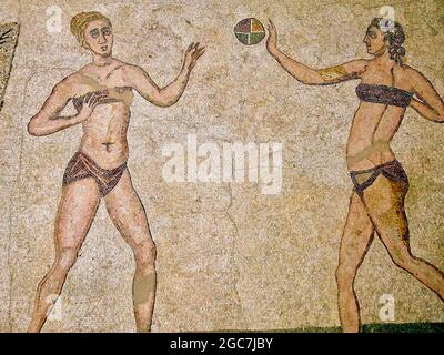 Roman Bikini Mosaics at The Villa Romana del Casale, Sicily, Italy. Early depiction of Roman women wearing bikinis from early 4th century AD. Stock Photo