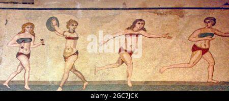 Roman Bikini Mosaics at The Villa Romana del Casale, Sicily, Italy. Early depiction of Roman women wearing bikinis from early 4th century AD. Stock Photo