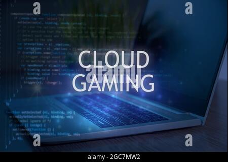Cloud gaming inscription against laptop and code background. Technology concept. Stock Photo