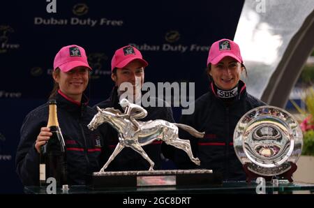 (left to right) Ladies team captain Hayley Turner, and jockeys Mickaelle Michel and Nicola Currie collecting the Dubai Duty Free Shergar Cup at Ascot Racecourse. Picture date: Saturday August 7, 2021. See PA story RACING Ascot. Photo credit should read: Steven Paston/PA Wire. RESTRICTIONS: Use subject to restrictions. Editorial use only, no commercial use without prior consent from rights holder. Stock Photo