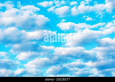 Beautiful white clouds float across the blue fairytale sky. Relaxation and relaxation Stock Photo