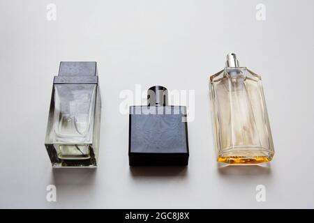 Three glass perfume bottles isolated on white background Stock Photo