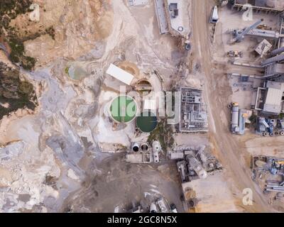 Quarry with Stone sorting conveyor belts and an open pit mine.  Stock Photo