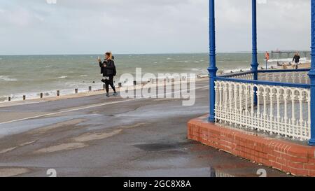 Woman taking a selfie on the beachfront of Bognor Regis in summer 2021. Stock Photo