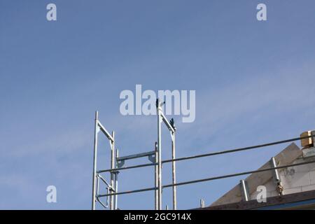 contruction site with gloves left for drying on construction site with blue sky, Nuremberg, Germany Stock Photo