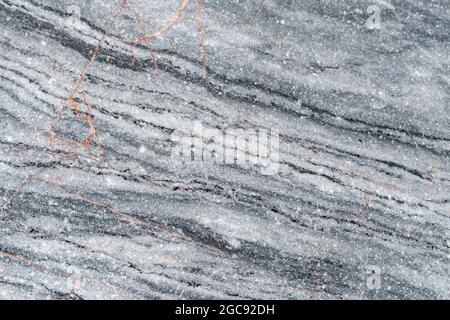 A closeup of natural limestone rock. Very fine detail (this is not noise). Small rusty orange veins. Stock Photo