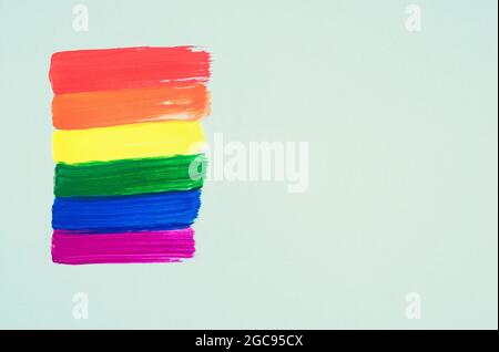 Hand painted LGTBY gay flag on green background. Space to copy. Stock Photo