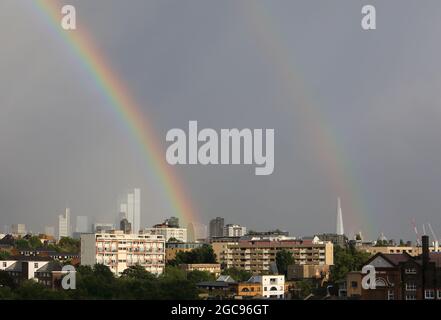 London, UK, August 7th 2021. Stormy weather, with heavy showers alternating with sunny spells resulted in a beautiful evening double rainbow over the skyscrapers in the City of  London. Monica Wells/Alamy Live News Stock Photo