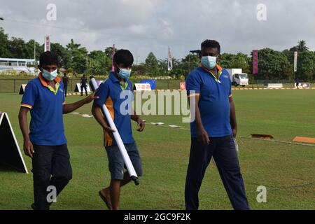 Ground staff at the picturesque Army Ordinance cricket grounds. Dombagoda. Sri Lanka.