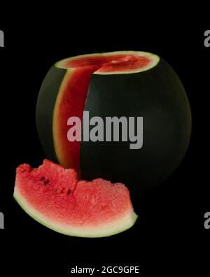 Ripe watermelon with cut piece of watermelon, on black background Stock Photo