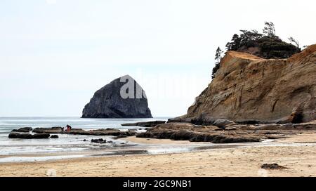 Along the Oregon Coast: Cape Kiwanda State Natural Area with Haystack Rock looking from the beach at Pacific City. Stock Photo