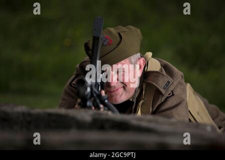 1st August 2021. Castle Rising, Norfolk, UK. Soldiers Through the Ages event at Castle Rising, the first public event at the 12th Century castle since before the Covid pandemic outbreak. Chris Page in full 1st Battalion Kings Royal rifle Corps uniform and armed with a MKI (1941), in honour of his late father who served with the battalion during the Second World War. Stock Photo