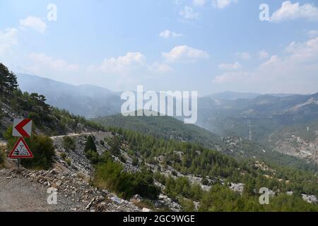 07 August 2021, Turkey, Köycegiz: Smoke rises over the landscape of the community in Mugla, western Turkey. Ten days ago, fires broke out in numerous provinces of Turkey. Vast areas of forest, fields and villages have since gone up in flames. Photo: Anne Pollmann/dpa Stock Photo
