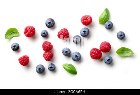 composition of fresh berries and green leaves isolated on white background, top view Stock Photo