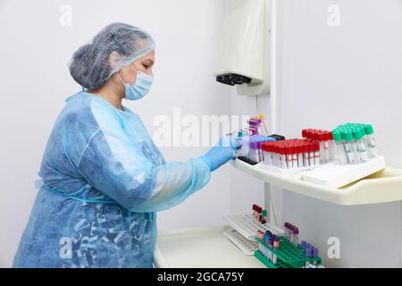 Scientist working with blood sample in laboratory Stock Photo