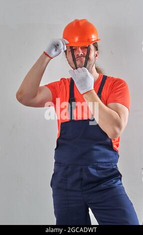 foreman chief trying to put a helmet on his head Stock Photo