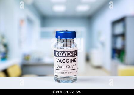 COVID-19 vaccine vial in clinic, bottle with corona virus vaccine for injection in doctor office or vaccination center. Concept of health, coronavirus Stock Photo