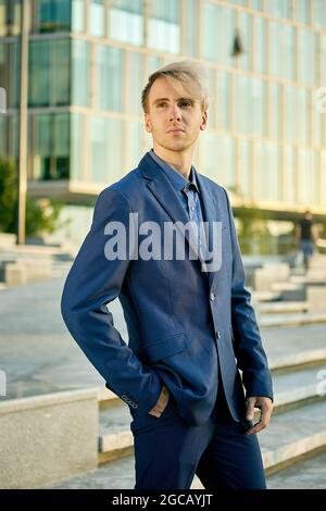 Man in business suit is standing near office center. Stock Photo