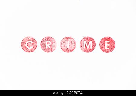 Red color rubber stamp in word crime on white paper background Stock Photo