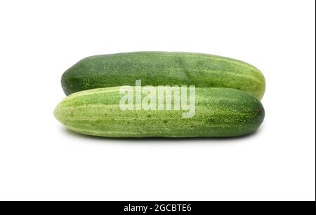 Two fresh organic green cucumbers on isolated white background Stock Photo