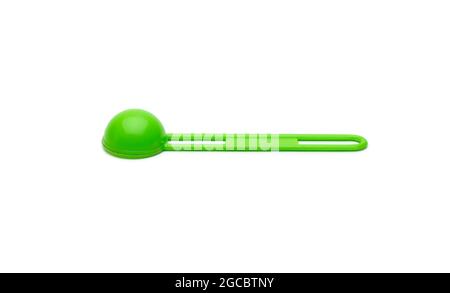 Isolated green measuring plastic spoon on white background Stock Photo
