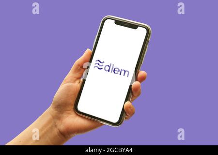 Tashkent, Uzbekistan - April 2, 2021: Hand holds mobile phone with Diem logo. Stock Photo