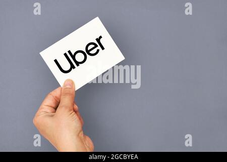 Tashkent, Uzbekistan - April 2, 2021: Hand holds a card with Uber logo Stock Photo