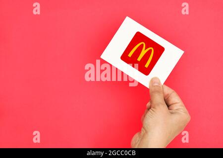 Tashkent, Uzbekistan - April 2, 2021: Hand holds a card with McDonalds logo Stock Photo