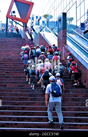 Children on School outing climbing the Grand Stairway of the Kyoto Station leading to the Sky Garden on the 15th floor, Kyoto Station, Kyoto, Japan Stock Photo