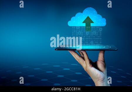 Digital data set of binary numbers being sent to the clouds on a blue background. Stock Photo