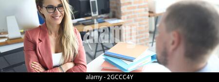 Businesswoman and businessman are discussing business processes at working table Stock Photo