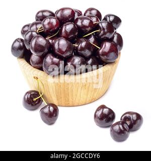 Sweet cherry berries in wooden bowl isolated on white background. Stock Photo