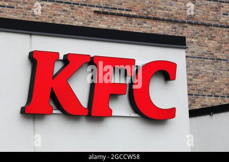 Horsens, Denmark - May 13, 2021: KFC logo on a facade. KFC is a fast food restaurant chain that specializes in fried chicken Stock Photo