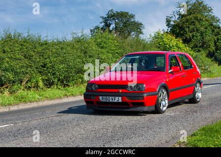 1998 90s nineties red VW Volkswagen GTi 5 speed manual 4dr 1984 cc petrol saloon en-route to Capesthorne Hall classic July car show, Cheshire, UK Stock Photo
