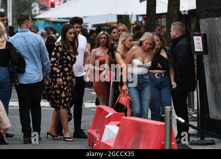 Club goers hit Wind Street in Swansea, on Saturday night as nightclubs open across Wales for the first time since the start of the pandemic, as well as facemask restriction being no longer mandatory inside pubs. Stock Photo