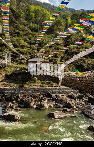 ancient holy iron bridge with many buddhist holy flags from flat angle image is taken at chaksam bridge tawang arunachal pradesh india. Stock Photo