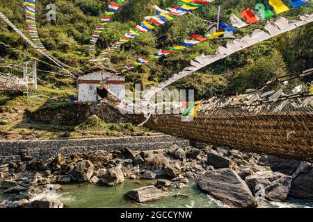 ancient holy bamboo bridge with many buddhist holy flags from flat angle image is taken at chaksam bridge tawang arunachal pradesh india. Stock Photo