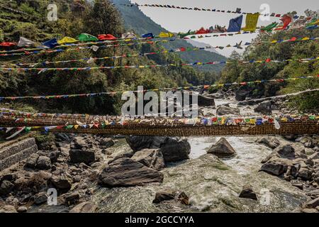 ancient holy bamboo bridge with many buddhist holy flags from unique perspective image is taken at chaksam bridge tawang arunachal pradesh india. Stock Photo