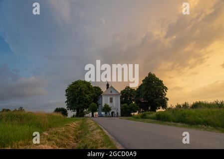 Small temple hidden between trees Stock Photo