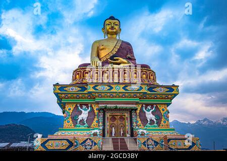 huge buddha golden statue from different perspective with moody sky at evening image is taken at giant buddha statue tawang arunachal pradesh india. Stock Photo