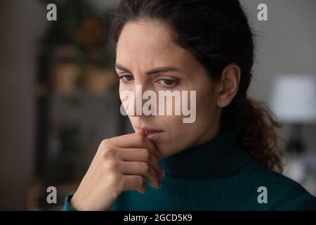 Close up thoughtful upset woman thinking about problems alone Stock Photo