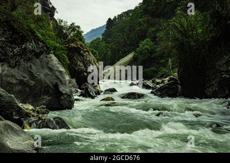 mountain river extreme water flow at day long exposure image is taken at dirang river tawang arunachal pradesh india. Stock Photo