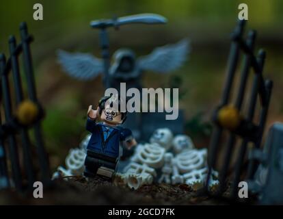 Lego minifigure run from cementary Stock Photo