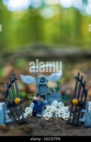 Lego minifigure run from cementary Stock Photo