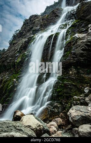 waterfall white water stream falling from mountains at day from flat angle image is taken at jang waterfall tawang arunachal pradesh. Stock Photo