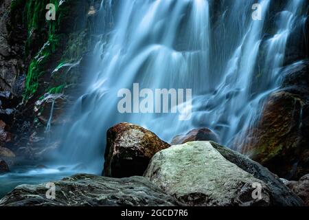 waterfall white water stream falling from mountains at day long exposure image is taken at jang waterfall tawang arunachal pradesh. Stock Photo