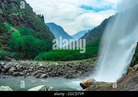 waterfall white water stream falling from mountains with valley at day long exposure image is taken at jang waterfall tawang arunachal pradesh. Stock Photo