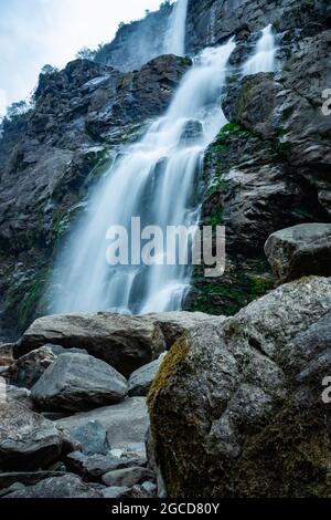 waterfall white water stream falling from mountains at day from flat angle image is taken at jang waterfall tawang arunachal pradesh. Stock Photo